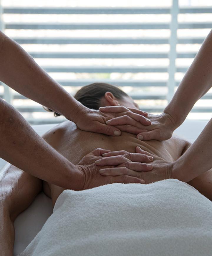 Massaggio a quattro mani, relax e benessere totale su un lettino