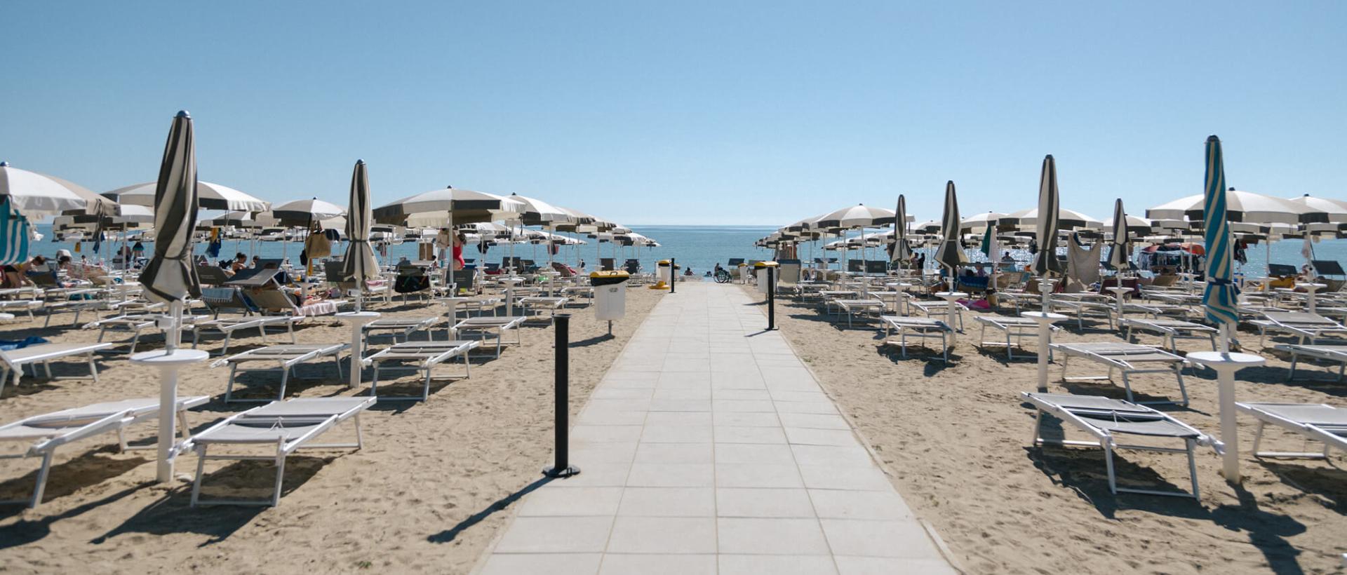 Spiaggia privata con ombrelloni e accesso diretto al villaggio